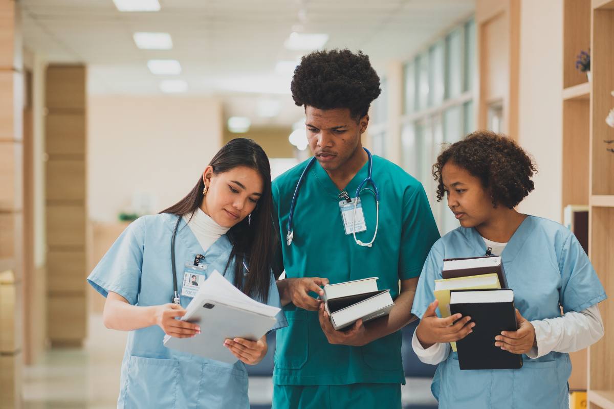 A group of students study the Patricia Benner nursing theory before class.