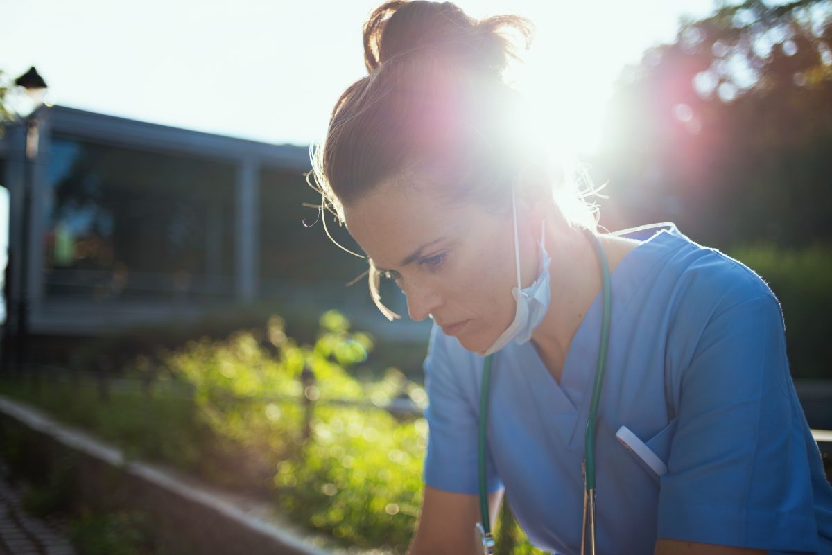 Image of a female nurse sitting outside on a break