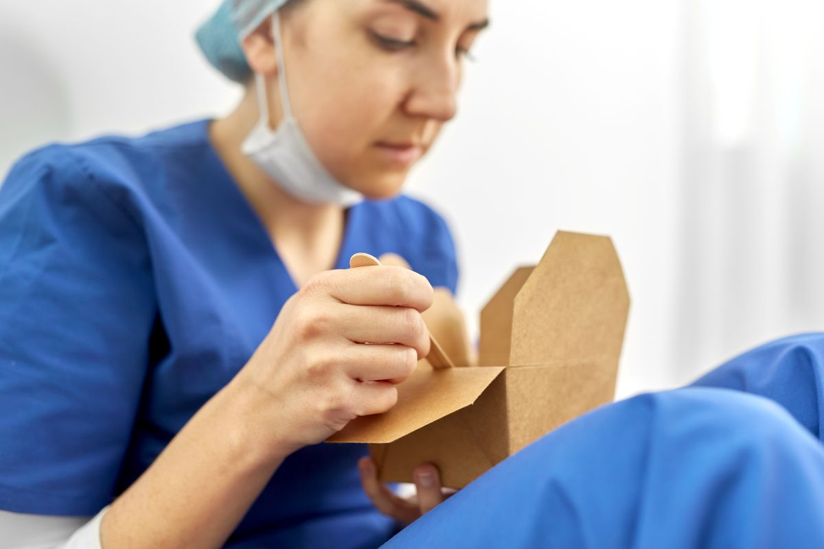 A nurse eats leftovers during her lunch break.