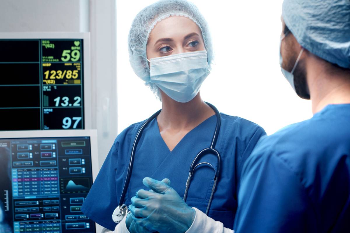 A nurse practitioner with ENP-C certification speaks with a colleague.