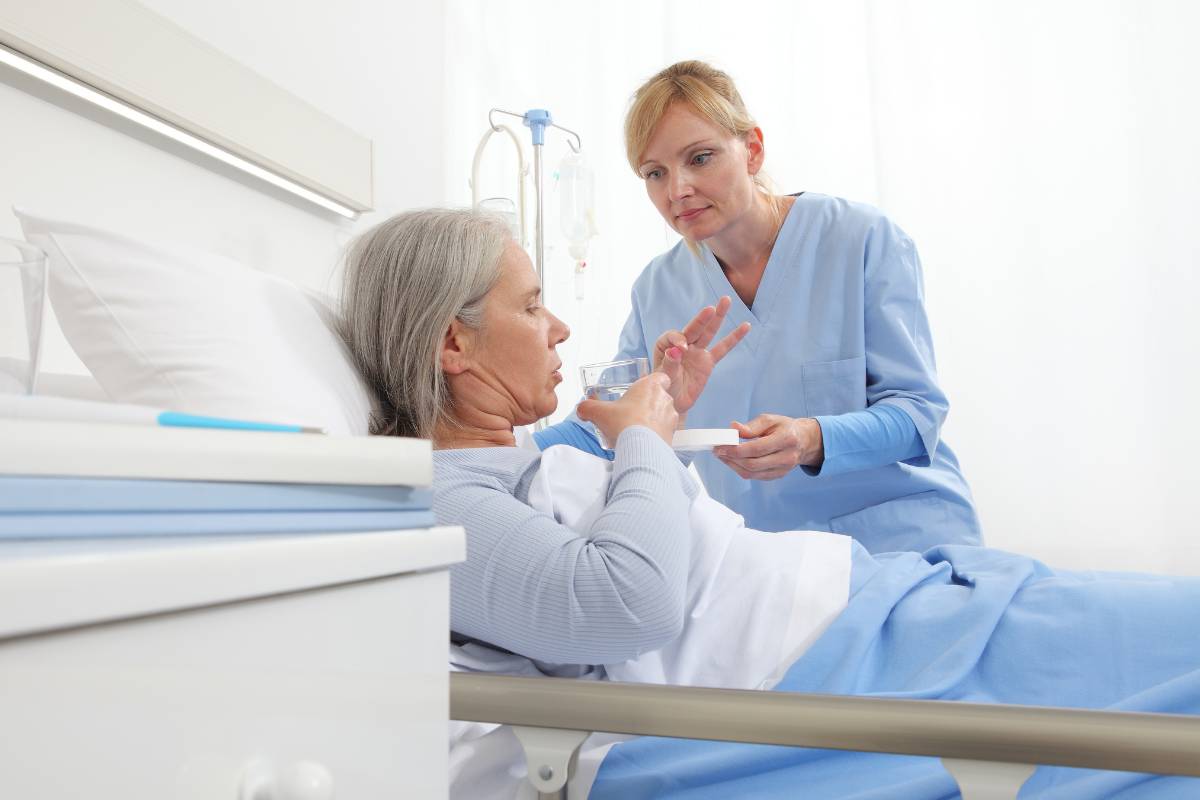 A nurse assists a patient while discussing fun facts about licensed practical nurses.