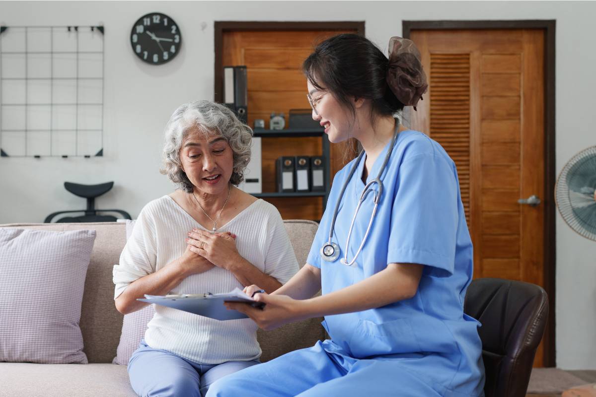 A nurse shows a patient a chart while discussing how to become an RN in Arizona.