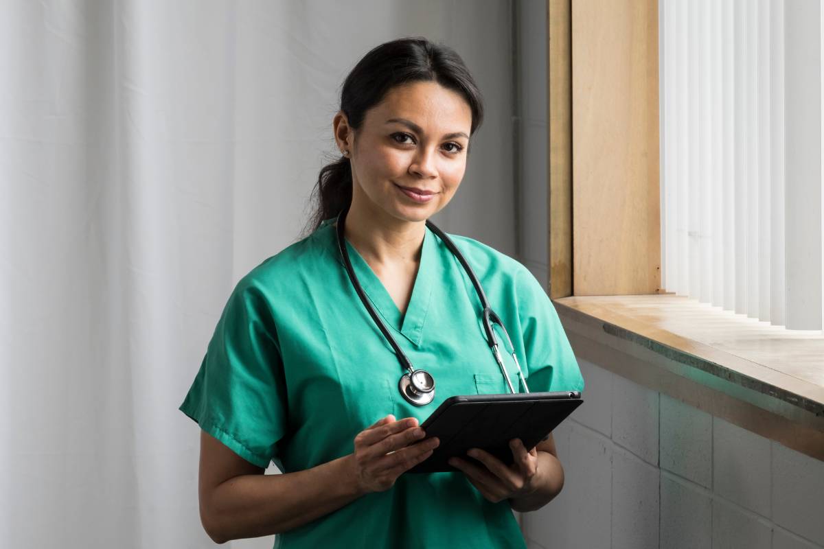 A nurse poses for a photo while discussing how to become an RN in PA.