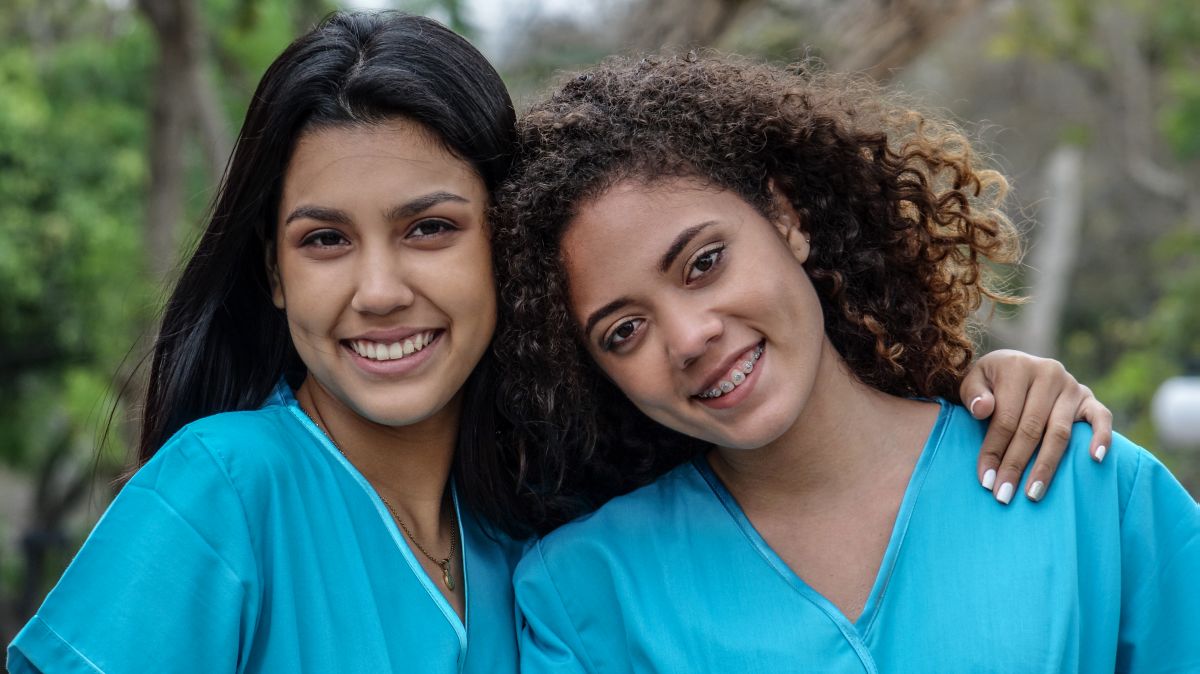 Two new grad RNs pose for the camera.