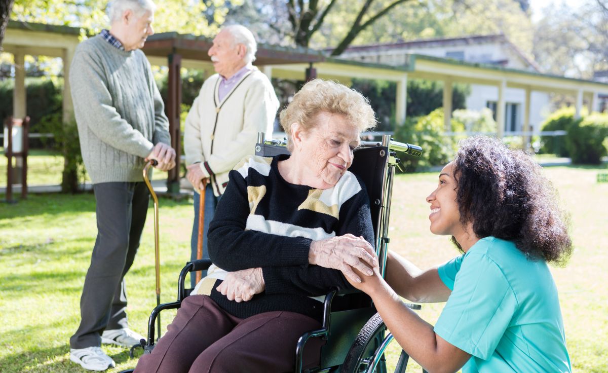 A nurse talks with a nursing home resident.