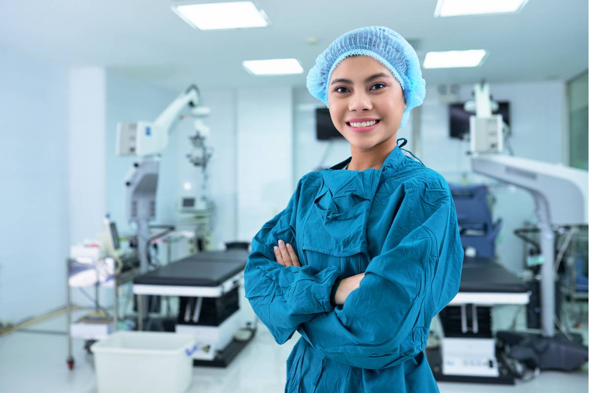 A nurse with CSC certification poses for a photo in an operating room.